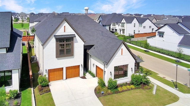 14085 Nicollet Dr, Frisco, TX 75033 - view of front of home featuring a residential view, an attached garage, driveway, roof with shingles, and a front lawn