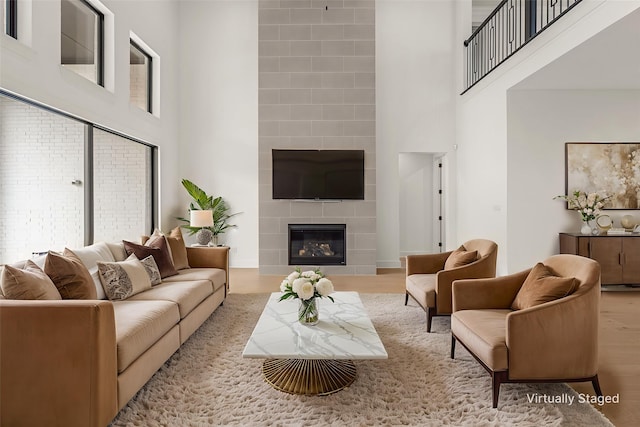14085 Nicollet Dr, Frisco, TX 75033 - living area featuring a high ceiling, wood finished floors, and a fireplace