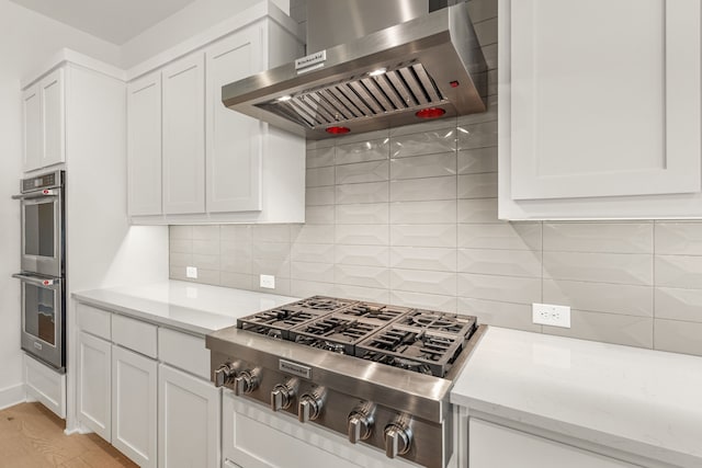 14085 Nicollet Dr, Frisco, TX 75033 - kitchen featuring wall chimney exhaust hood, appliances with stainless steel finishes, and white cabinets