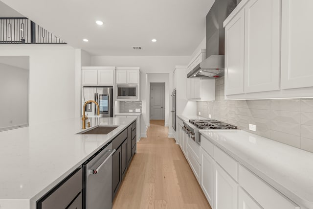 14085 Nicollet Dr, Frisco, TX 75033 - kitchen featuring stainless steel appliances, wall chimney exhaust hood, a sink, white cabinetry, and recessed lighting