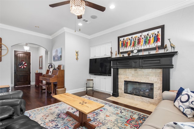 3042 Preston Club Dr, Sherman, TX 75092 - living area with ceiling fan, arched walkways, ornamental molding, dark wood-type flooring, and a stone fireplace