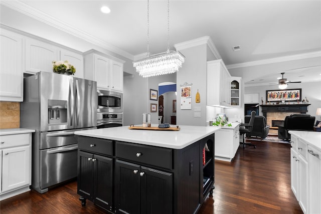 3042 Preston Club Dr, Sherman, TX 75092 - kitchen featuring appliances with stainless steel finishes, white cabinets, arched walkways, light countertops, and ornamental molding
