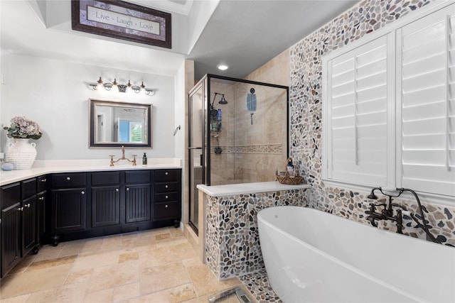 3042 Preston Club Dr, Sherman, TX 75092 - bathroom featuring a freestanding bath, a stall shower, stone tile flooring, vanity, and recessed lighting