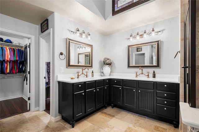 3042 Preston Club Dr, Sherman, TX 75092 - full bath with double vanity, stone tile floors, a spacious closet, and baseboards