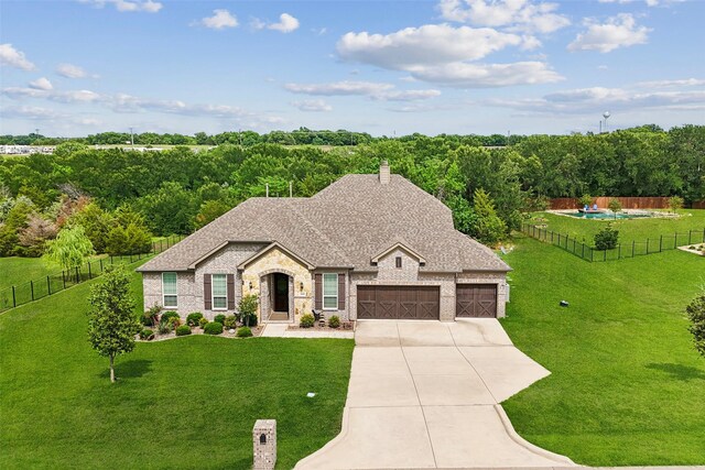 2608 Morning Mist Ln, Nevada, TX 75173 - french country home featuring driveway, an attached garage, roof with shingles, a chimney, and stone siding