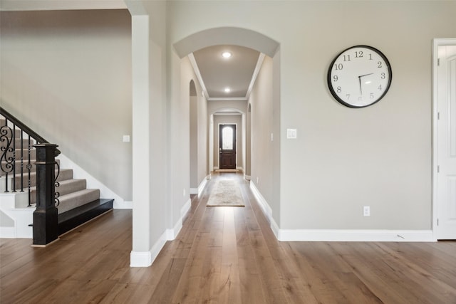 2608 Morning Mist Ln, Nevada, TX 75173 - foyer entrance with arched walkways, wood finished floors, crown molding, baseboards, and stairs