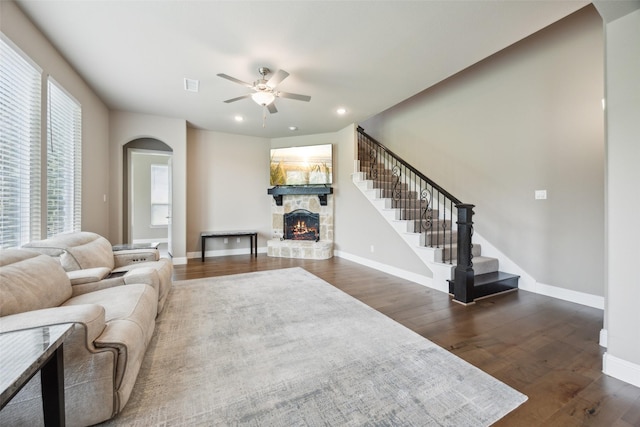 2608 Morning Mist Ln, Nevada, TX 75173 - living room with arched walkways, a fireplace, a ceiling fan, dark wood-style floors, and recessed lighting