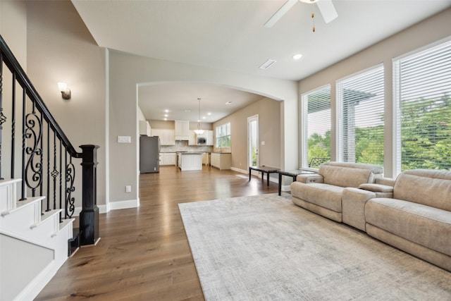 2608 Morning Mist Ln, Nevada, TX 75173 - living room with recessed lighting, arched walkways, dark wood-style flooring, ceiling fan, and baseboards