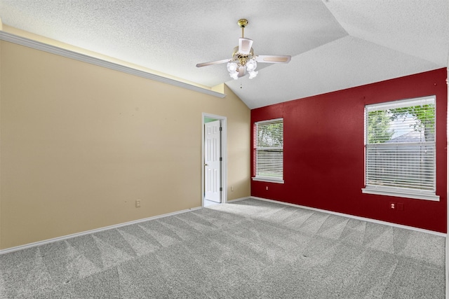 1505 Hyde Park Blvd, Cleburne, TX 76033 - empty room with lofted ceiling, carpet flooring, a ceiling fan, a textured ceiling, and baseboards