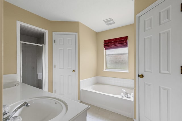 1505 Hyde Park Blvd, Cleburne, TX 76033 - bathroom with double vanity, a garden tub, tile patterned floors, and a stall shower