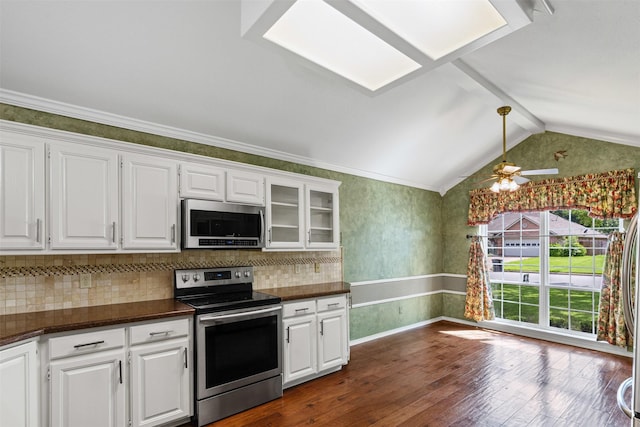 1505 Hyde Park Blvd, Cleburne, TX 76033 - kitchen with stainless steel appliances, dark countertops, dark wood finished floors, white cabinetry, and lofted ceiling