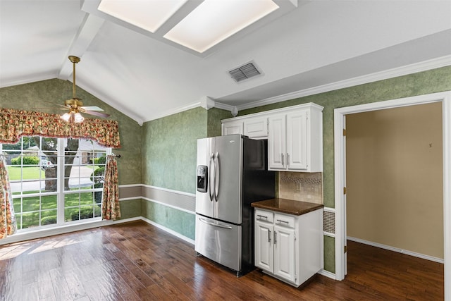 1505 Hyde Park Blvd, Cleburne, TX 76033 - kitchen with stainless steel fridge with ice dispenser, dark wood finished floors, dark countertops, white cabinets, and lofted ceiling