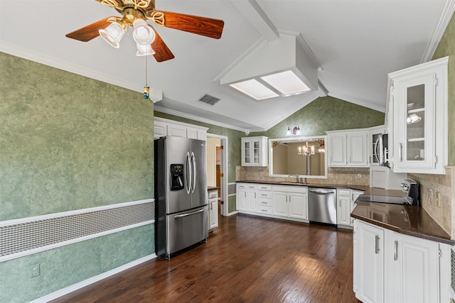 1505 Hyde Park Blvd, Cleburne, TX 76033 - kitchen with appliances with stainless steel finishes, a sink, dark countertops, dark wood-style floors, and vaulted ceiling