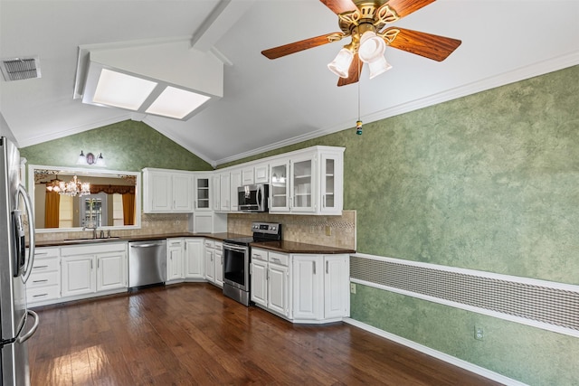 1505 Hyde Park Blvd, Cleburne, TX 76033 - kitchen with appliances with stainless steel finishes, dark countertops, dark wood-type flooring, a chandelier, and lofted ceiling