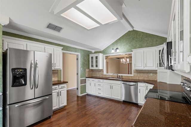 1505 Hyde Park Blvd, Cleburne, TX 76033 - kitchen with appliances with stainless steel finishes, a chandelier, a sink, white cabinets, and vaulted ceiling