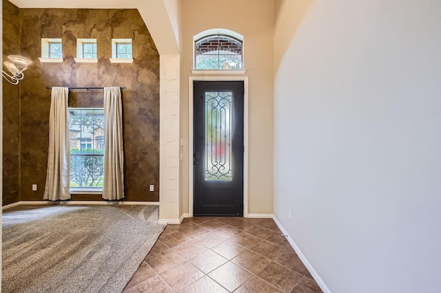 9028 Wiggins Dr, Fort Worth, TX 76244 - entrance foyer featuring healthy amount of natural light, baseboards, tile patterned flooring, and arched walkways