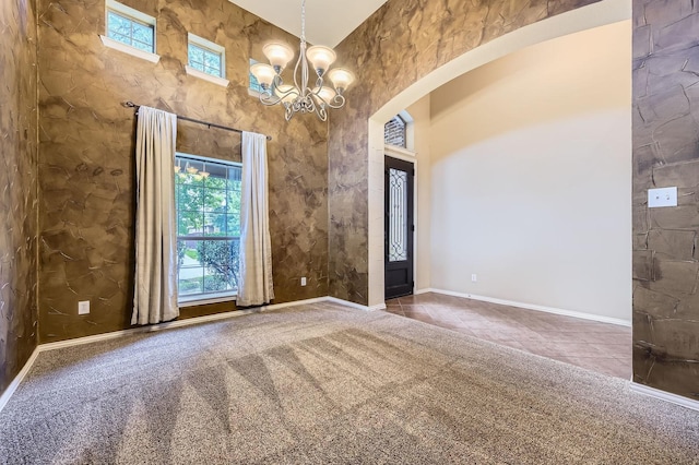 9028 Wiggins Dr, Fort Worth, TX 76244 - carpeted empty room with arched walkways, plenty of natural light, a chandelier, baseboards, and a high ceiling