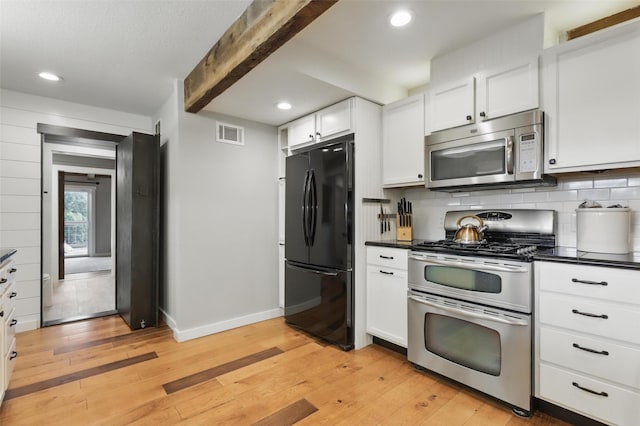 4009 Seminole Trl, Granbury, TX 76048 - kitchen with stainless steel appliances, dark countertops, baseboards, light wood finished floors, and beamed ceiling