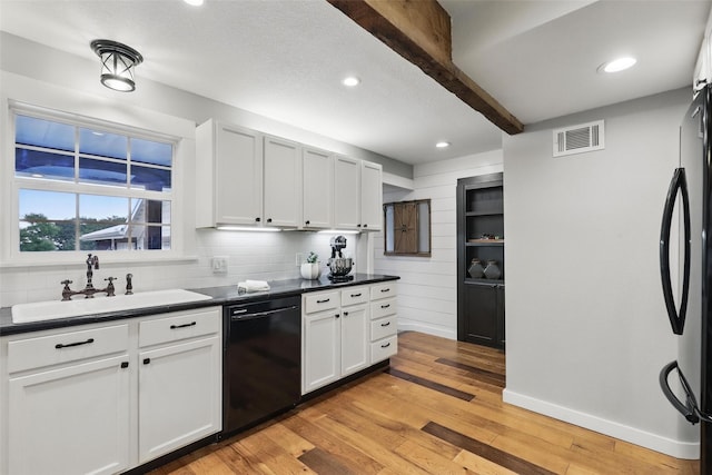 4009 Seminole Trl, Granbury, TX 76048 - kitchen featuring dishwasher, a sink, dark countertops, freestanding refrigerator, and recessed lighting