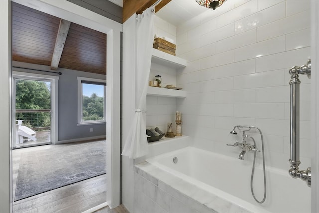 4009 Seminole Trl, Granbury, TX 76048 - full bathroom with a relaxing tiled tub, wood finished floors, and wooden ceiling with exposed beams