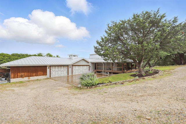 4009 Seminole Trl, Granbury, TX 76048 - view of front of home with metal roof, driveway, and a porch