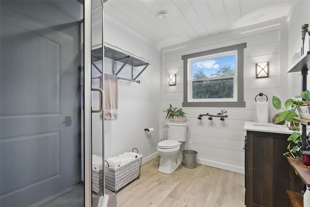 4009 Seminole Trl, Granbury, TX 76048 - bathroom with vanity, wood finished floors, a shower stall, and toilet