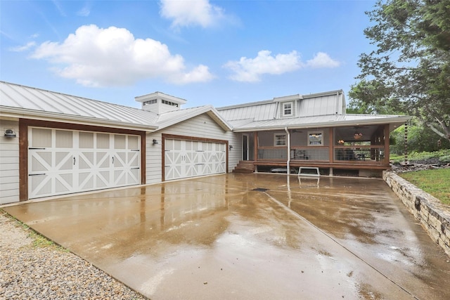 4009 Seminole Trl, Granbury, TX 76048 - view of front of house featuring a standing seam roof, an attached garage, metal roof, and driveway