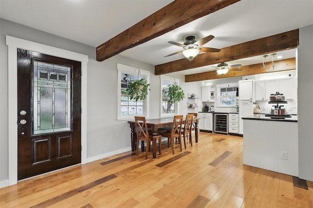 4009 Seminole Trl, Granbury, TX 76048 - dining room featuring beverage cooler, light wood-type flooring, ceiling fan, beam ceiling, and baseboards