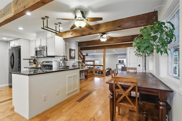 4009 Seminole Trl, Granbury, TX 76048 - kitchen featuring stove, freestanding refrigerator, a ceiling fan, stainless steel microwave, and beam ceiling