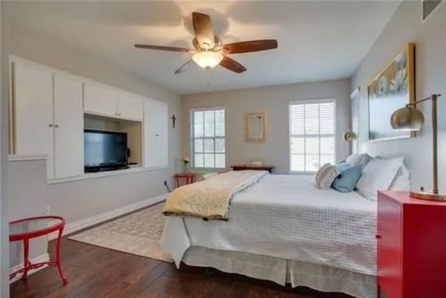 14 E Hillside Pl, Trophy Club, TX 76262 - bedroom with dark wood-style floors, multiple windows, ceiling fan, and baseboards