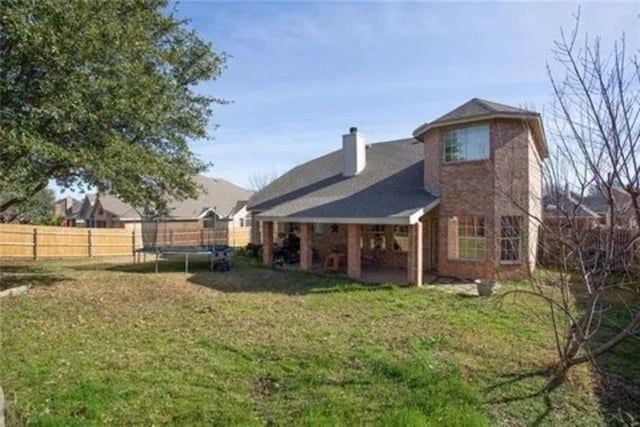 14 E Hillside Pl, Trophy Club, TX 76262 - rear view of house with a trampoline and a chimney