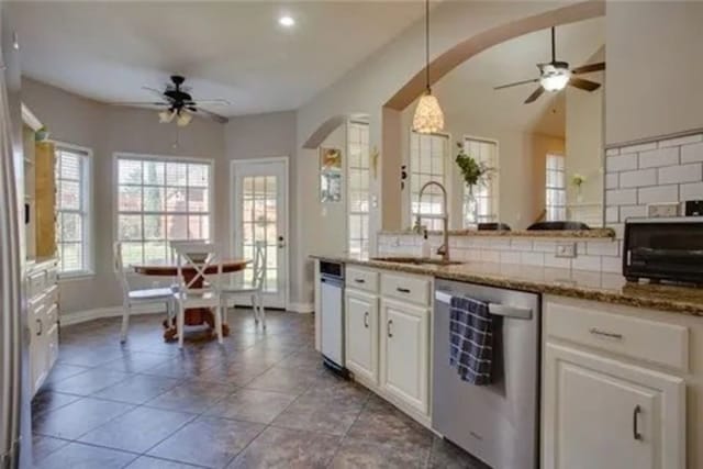 14 E Hillside Pl, Trophy Club, TX 76262 - kitchen with dishwasher, ceiling fan, a sink, backsplash, and white cabinetry