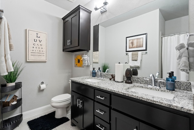 105 Aslan Rd, Poolville, TX 76487 - bathroom featuring double vanity, toilet, baseboards, and tile patterned floors