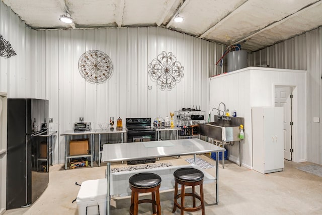 105 Aslan Rd, Poolville, TX 76487 - kitchen with black appliances, vaulted ceiling, concrete flooring, water heater, and a sink