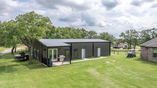 105 Aslan Rd, Poolville, TX 76487 - rear view of house with board and batten siding, french doors, a standing seam roof, metal roof, and a patio