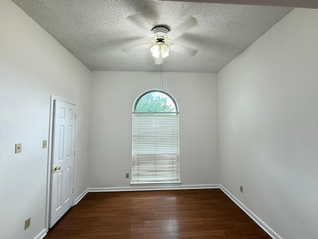 617 Desoto Dr, Desoto, TX 75115 - empty room featuring a ceiling fan, dark wood-style flooring, a textured ceiling, and baseboards