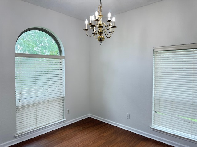 617 Desoto Dr, Desoto, TX 75115 - unfurnished room with a chandelier, dark wood-type flooring, and baseboards