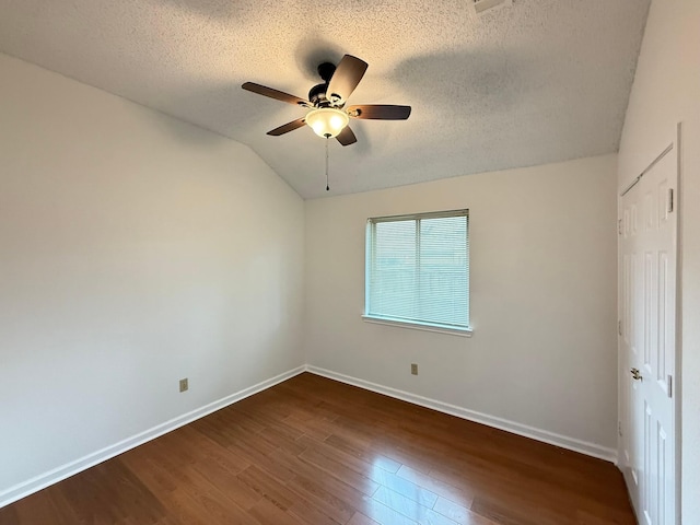 617 Desoto Dr, Desoto, TX 75115 - unfurnished bedroom featuring a textured ceiling, dark wood-style flooring, baseboards, a closet, and lofted ceiling