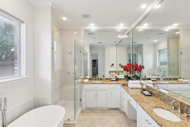 5920 Loch Lomond Dr, Plano, TX 75093 - bathroom featuring plenty of natural light, a stall shower, a soaking tub, double vanity, and crown molding