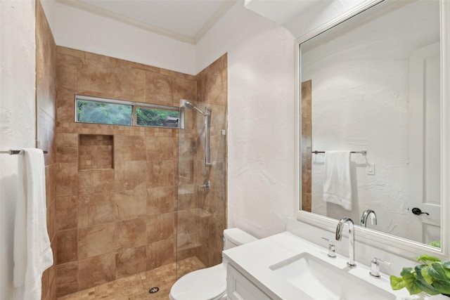 5920 Loch Lomond Dr, Plano, TX 75093 - bathroom featuring vanity, toilet, tiled shower, and crown molding