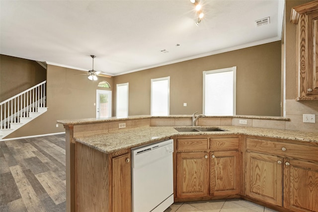 3116 Frazier Ave, Fort Worth, TX 76110 - kitchen featuring dishwasher, a sink, crown molding, brown cabinetry, and a ceiling fan