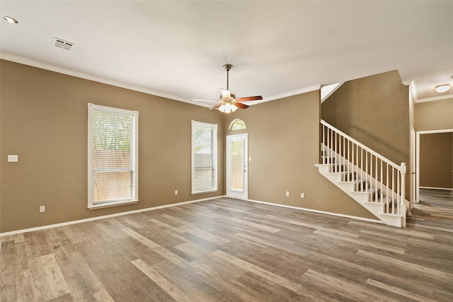3116 Frazier Ave, Fort Worth, TX 76110 - unfurnished living room with crown molding, wood finished floors, stairway, ceiling fan, and baseboards