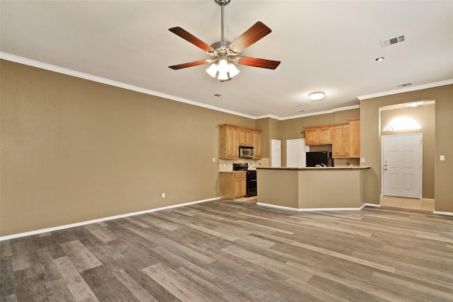 3116 Frazier Ave, Fort Worth, TX 76110 - kitchen with black / electric stove, open floor plan, stainless steel microwave, light wood-type flooring, and crown molding