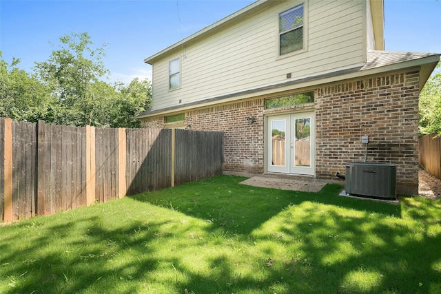 3116 Frazier Ave, Fort Worth, TX 76110 - rear view of house with central AC, brick siding, and french doors