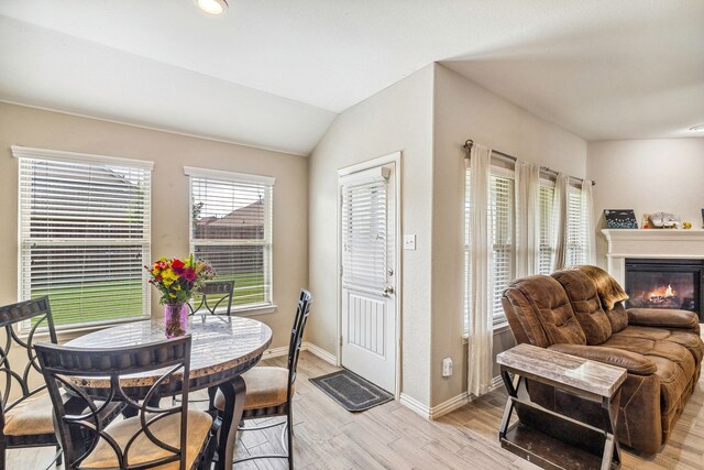 404 Madrone Ln, Princeton, TX 75407 - dining space featuring baseboards, light wood-type flooring, a glass covered fireplace, lofted ceiling, and recessed lighting