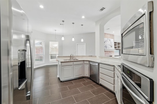 3402 Blue Forest Dr, Arlington, TX 76001 - kitchen with appliances with stainless steel finishes, a sink, a peninsula, light stone countertops, and recessed lighting
