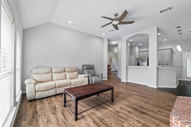 3402 Blue Forest Dr, Arlington, TX 76001 - living area featuring ceiling fan, dark wood-style floors, arched walkways, vaulted ceiling, and baseboards