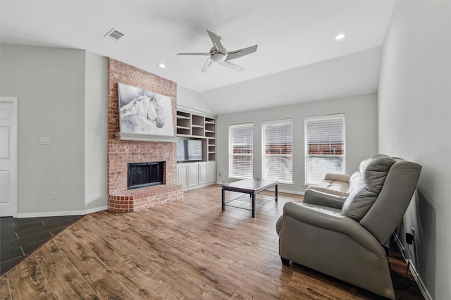 3402 Blue Forest Dr, Arlington, TX 76001 - living room with ceiling fan, vaulted ceiling, built in features, wood finished floors, and a fireplace