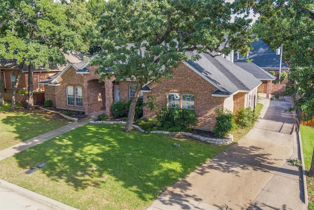 3402 Blue Forest Dr, Arlington, TX 76001 - view of front of property with brick siding, a front yard, and a shingled roof