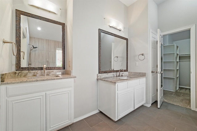 3402 Blue Forest Dr, Arlington, TX 76001 - bathroom with two vanities, a walk in closet, a tile shower, and tile patterned flooring
